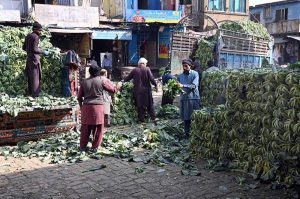 A worker is busy sorting good-quality onions at a vegetable market in the Federal Capital