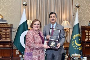 Acting President Syed Yousuf Raza Gilani presenting a souvenir to Ms. Marilina Armellin, Ambassador of the Italian Republic at Aiwan-e-Sadr.