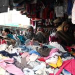 People shop for second-hand warm clothes at H-9 Weekly Bazaar as the mercury continues to drop in the federal capital