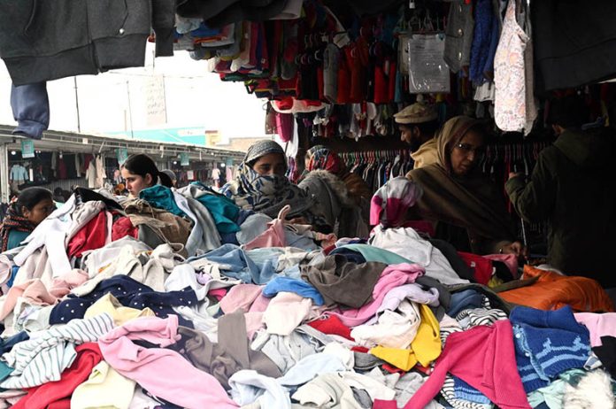 People shop for second-hand warm clothes at H-9 Weekly Bazaar as the mercury continues to drop in the federal capital