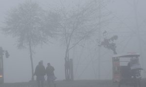 Motorcyclist pass through dense fog in the early morning along the expressway in the Federal Capital.