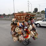 A vendor sells handmade items on his bicycle in the Federal Capital