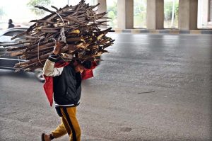 People are sitting around fire to keep themselves warm during cold weather in the Federal Capital