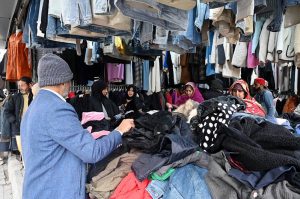 People shop for second-hand warm clothes at H-9 Weekly Bazaar as the mercury continues to drop in the federal capital
