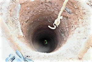 Labourers are busy digging a hole to install an electric pole at Khana Pul.