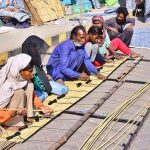 A family labour team busy preparing traditional bamboo curtains (chiks) at Court Road.