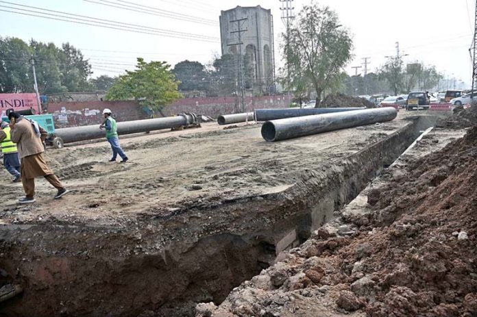 Workers are busy laying pipes for underground wires on Saidpur Road