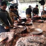 A vendor cuts and cleans fish for customers at H-9 Weekly Bazaar as demand for seafood rises during extreme cold weather in the federal capital