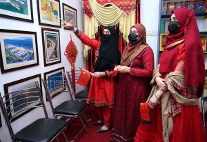 Female visitors taking interest in display china pictures during the celebration of Pak China Friendship 75th Anniversary at China Window
