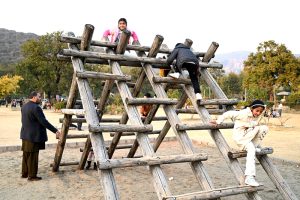 Children enjoying swings at a local park near F-6 sector