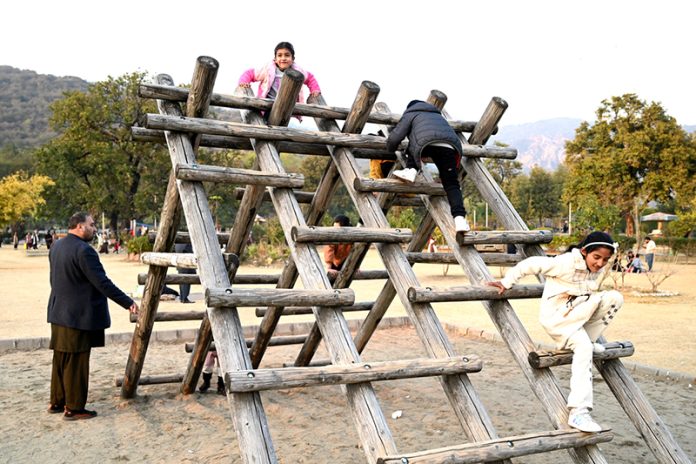 Children enjoying swings at a local park near F-6 sector