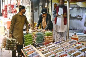 Women are busy selecting and purchasing bangles from vendor at Bangles Market. The bangles are supplied from Hyderabad to shops across the country.