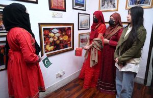 Female visitors taking interest in display china pictures during the celebration of Pak China Friendship 75th Anniversary at China Window