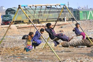 Gypsy youngsters enjoy jumping on the trampoline near Railway Station.