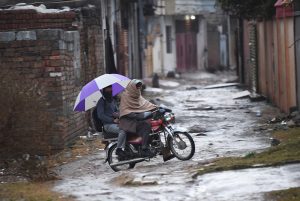 A view of rainfall as students head towards their schools in the Tarlai area of Federal Capital