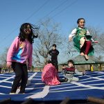 Children enjoy jumping on trampoline at a local park in the Federal Capital