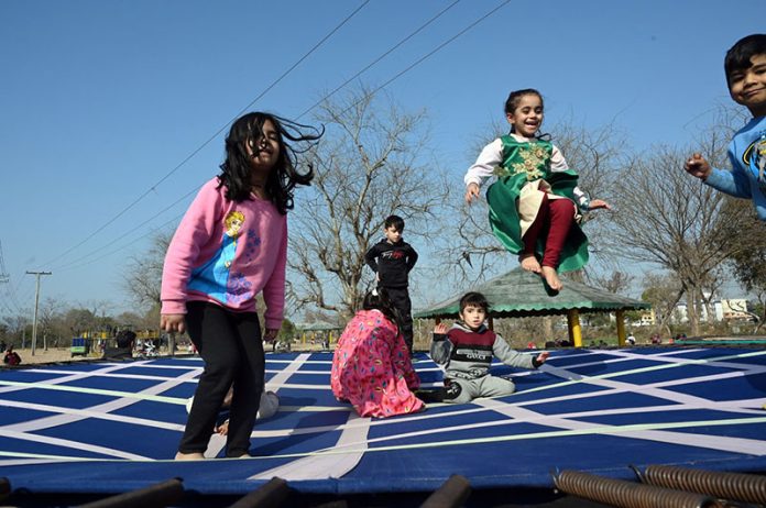 Children enjoy jumping on trampoline at a local park in the Federal Capital