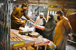 Women are busy selecting and purchasing bangles from vendor at Bangles Market. The bangles are supplied from Hyderabad to shops across the country.