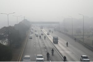Motorcyclist pass through dense fog in the early morning along the expressway in the Federal Capital.
