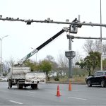 A worker busy repairing CCTV cameras during maintenance work at Srinagar Highway in Federal Capital