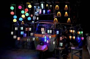 A vendor displaying decorative lamps and lights to attract the customers in Provincial Capital.