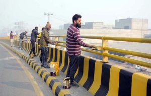 “Workers are busy painting the fence wall at Abdullahpur Jhumra Road Bridge.