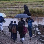 A view of rainfall as students head towards their schools in the Tarlai area of Federal Capital