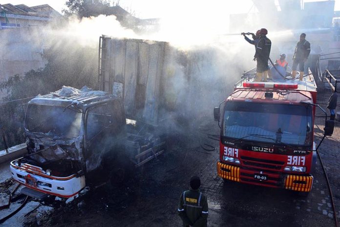 Firefighters battle to control a blaze at a CNG filling station along the bypass