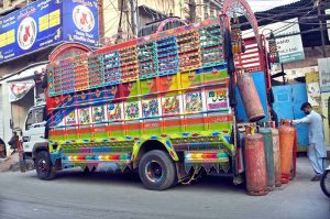 Labourers are busy unloading LPG cylinders from a delivery truck as demand increases during the cold weather in the provincial capital