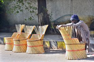 A worker busy in preparing traditional chair for selling at Court Road.
