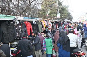A large number of people busy selecting and purchasing warm clothes from vendors in Provincial Capital.