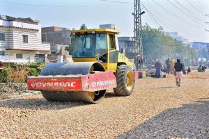 Labourers are busy construction work of road at Latifabad during development work in the city.