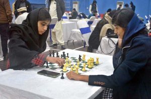 Girls participating in chess competition.