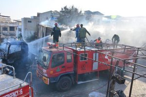 Firefighters battle to control a blaze at a CNG filling station along the bypass