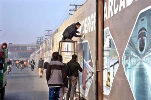 Workers are busy installing steel plates on the sides of Taksali Road.