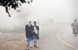 A dense blanket of fog envelops the entire Federal Capital during the early morning hours as children head to school amid low temperatures