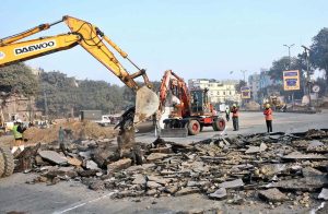 Workers are busy demolishing the road with heavy machinery for widen the Data Darbar Road.