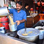 Amid the chill, a vendor prepares hot special tea to warm up customers at a local hotel