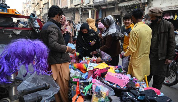 Family busy purchasing children’s toys at Landa Bazaar