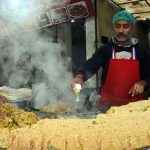 A shopkeeper prepares traditional food on Ferozepur Road at his setup