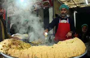 A shopkeeper prepares traditional food on Ferozepur Road at his setup