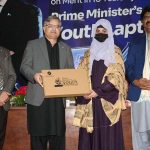 Vice Chancellor Allama Iqbal Open University Prof. Dr. Nasir Mahmood distributing laptops among students during laptop distribution ceremony held under Prime Minister’s Laptop Scheme at Regional Campus, Allama Iqbal Open University, Millat Town, Faisalabad.