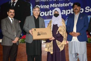 Vice Chancellor Allama Iqbal Open University Prof. Dr. Nasir Mahmood distributing laptops among students during laptop distribution ceremony held under Prime Minister’s Laptop Scheme at Regional Campus, Allama Iqbal Open University, Millat Town, Faisalabad.