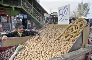 A vendor sells a variety of dry fruits at Faizabad as demand rises amid chilly weather following a drop in temperature in the twin cities.