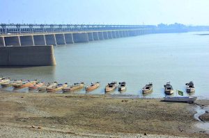 A fisherman busy throwing net for catching fish in Indus River