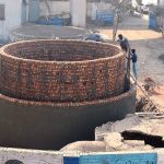 Workers are constructing a large main sewage disposal line at Chungi No. 09