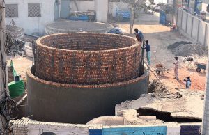 Workers are constructing a large main sewage disposal line at Chungi No. 09