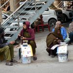 Daily wage laborers wait for customers near Mozang Chungi