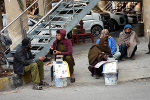 Daily wage laborers wait for customers near Mozang Chungi