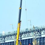 Workers of Irrigation department busy repairing and cleanup the Kotri Barrage Bridge doors with help of heavy machines at Indus River, Jamshoro